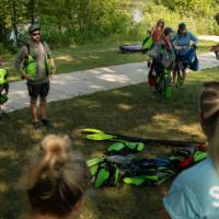 group listening and donning lifejackets outside